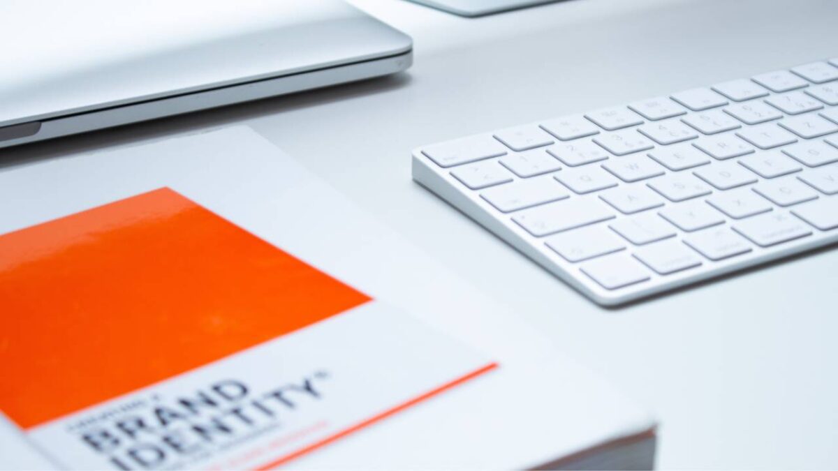 A closeup photo of a keyboard and a book 