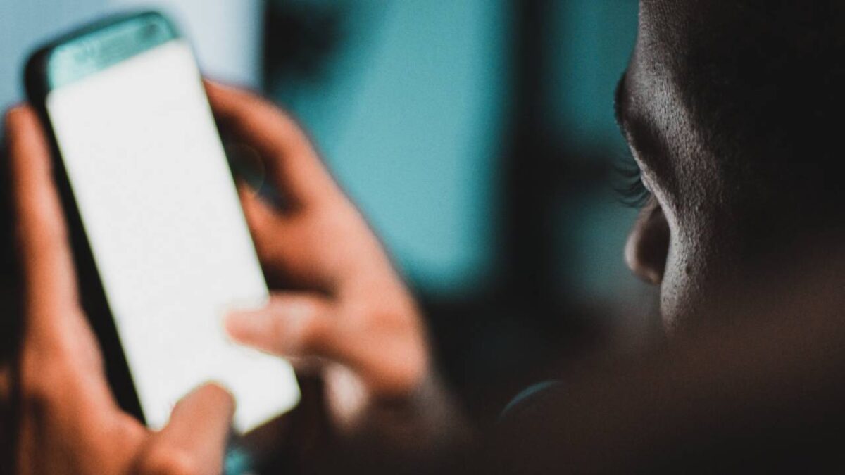 A closeup photo of a man using his smartphone