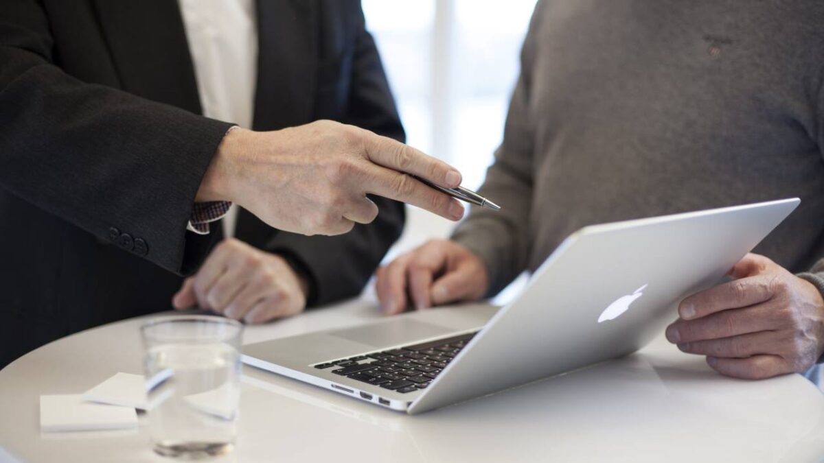 A client and his consultant using a laptop