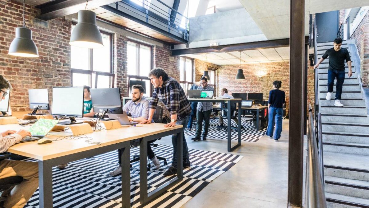 Employees working in a spacious and well-lit attic office