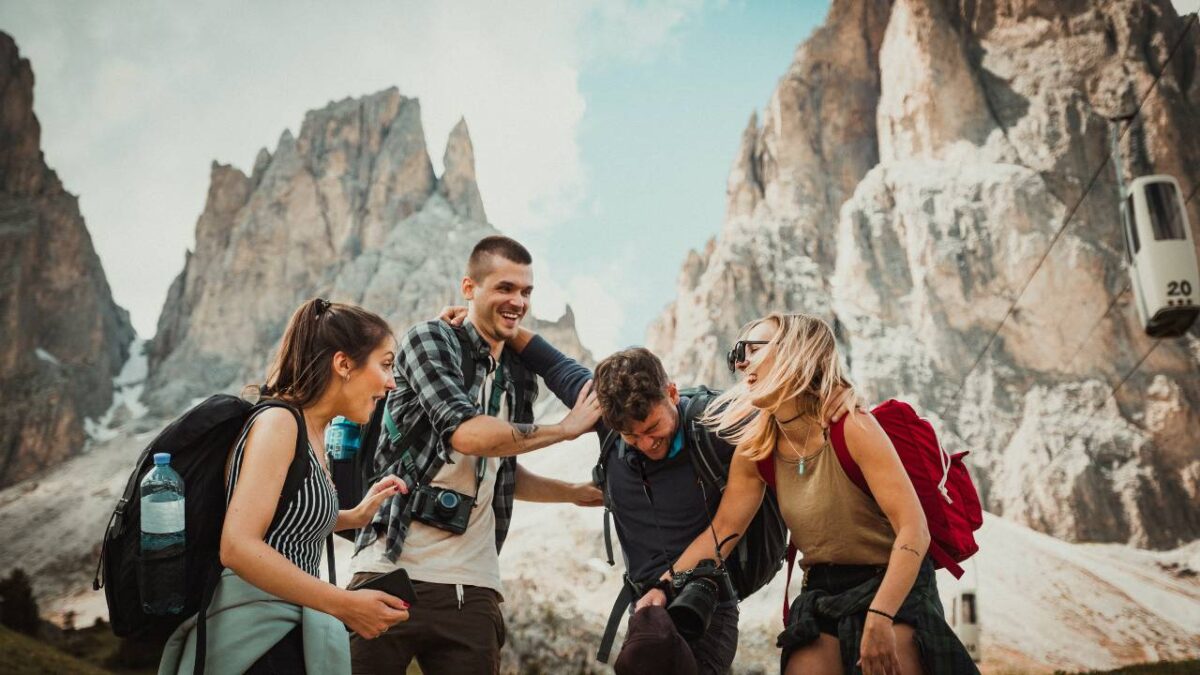 Four happy outdoor enthusiasts hiking together