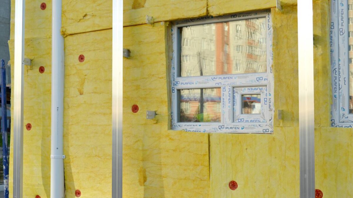 An exterior of a house with yellow insulation