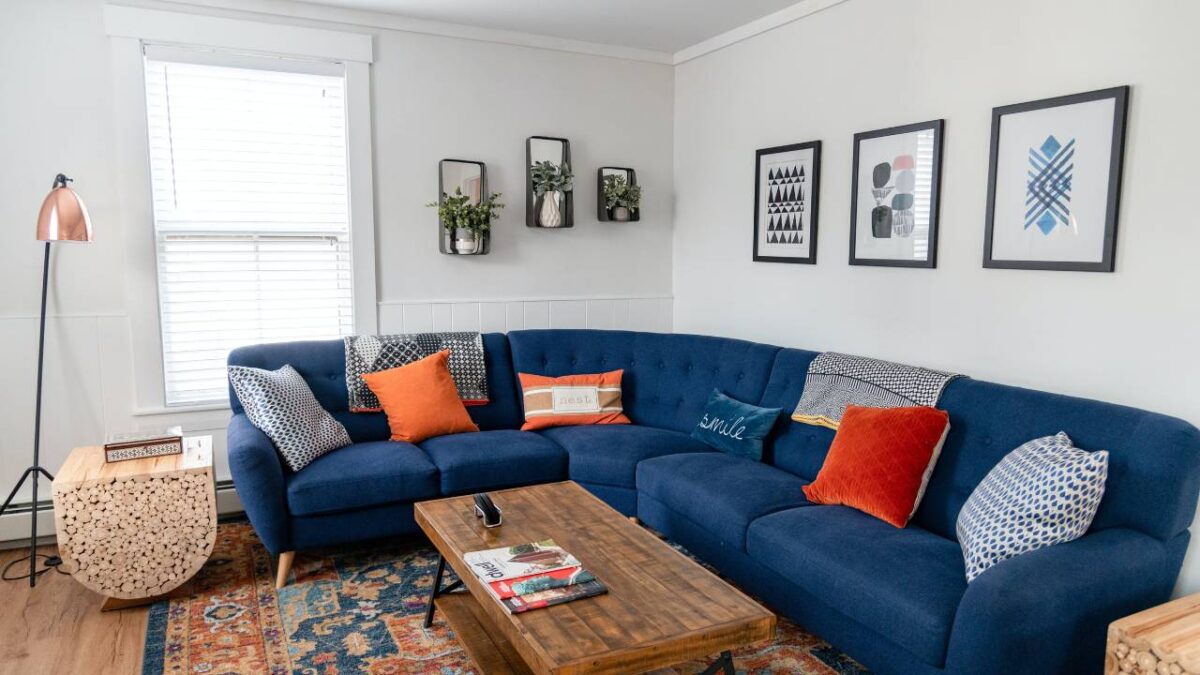 A large blue sofa in the corner of an apartment