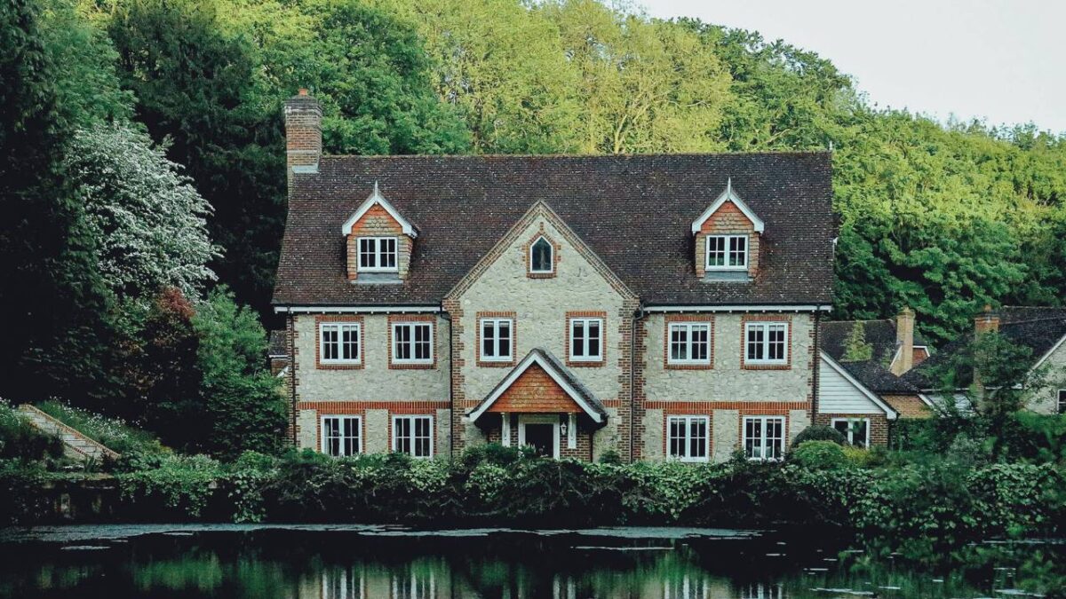 An older house surrounded by lush vegetation