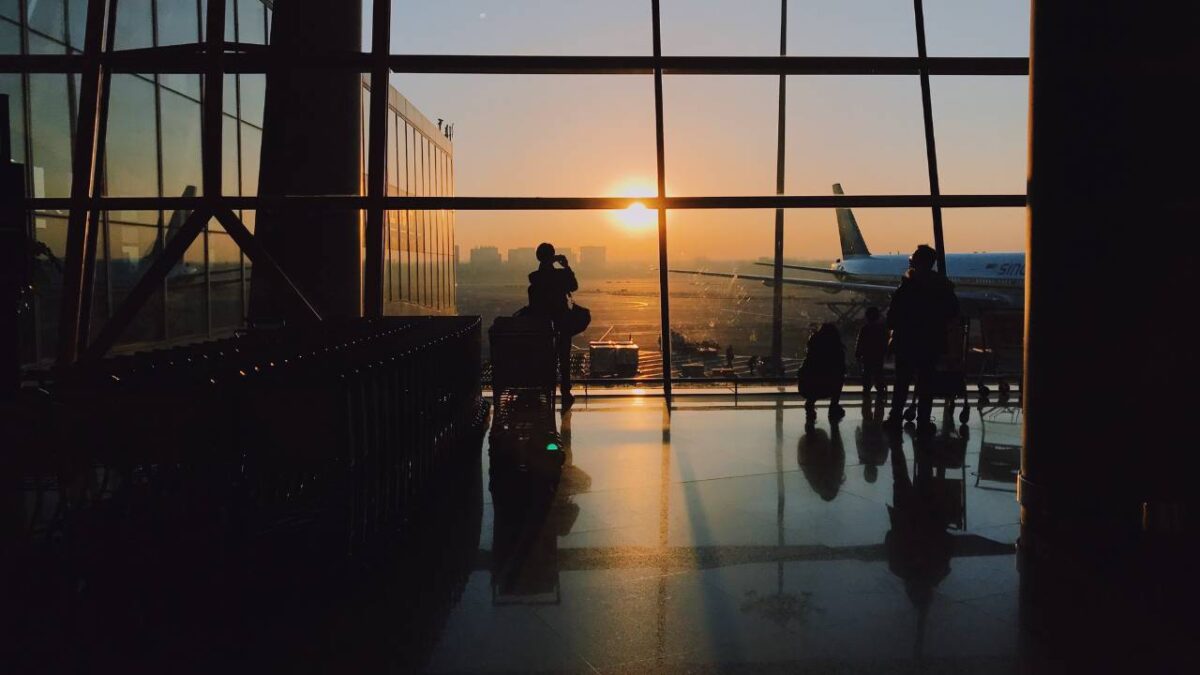 People at the airport looking at the sunset