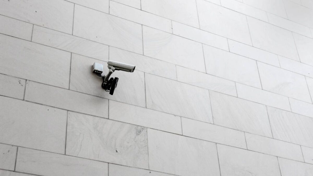 A CCTV camera on a white wall