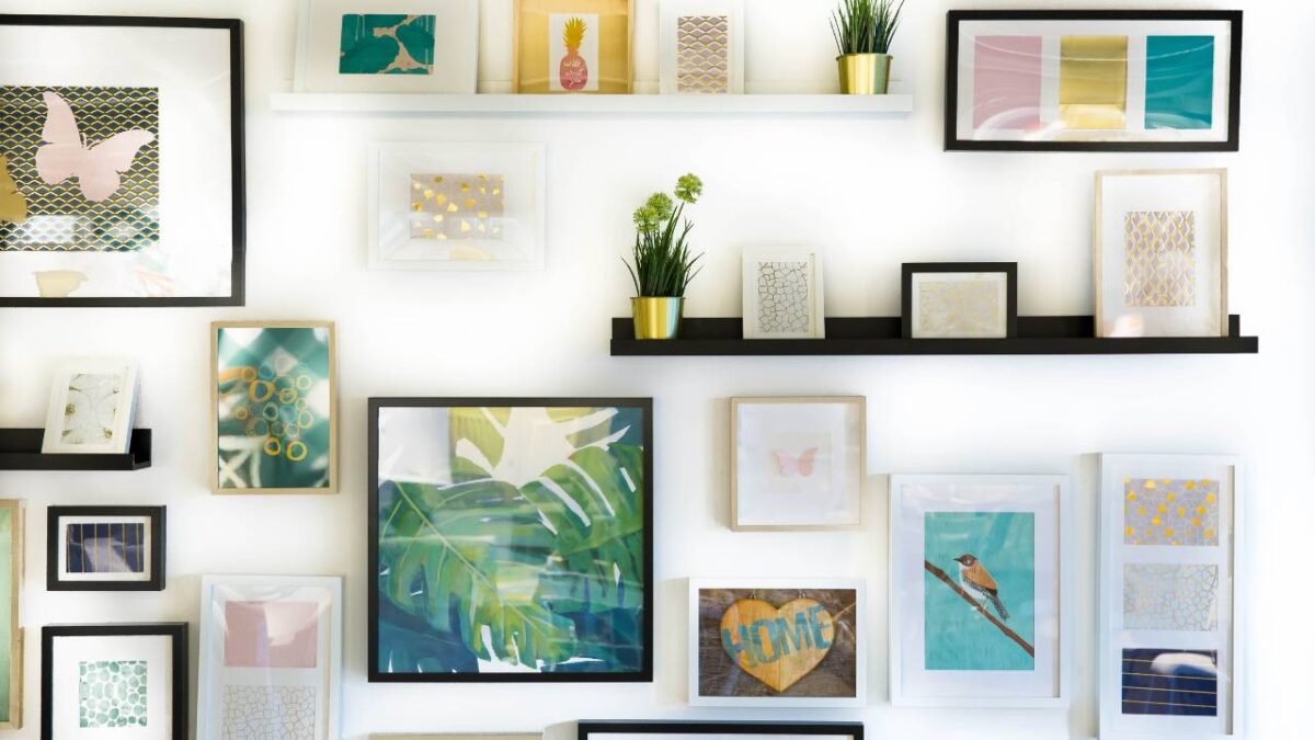 A white wall decorated with many colourful pictures