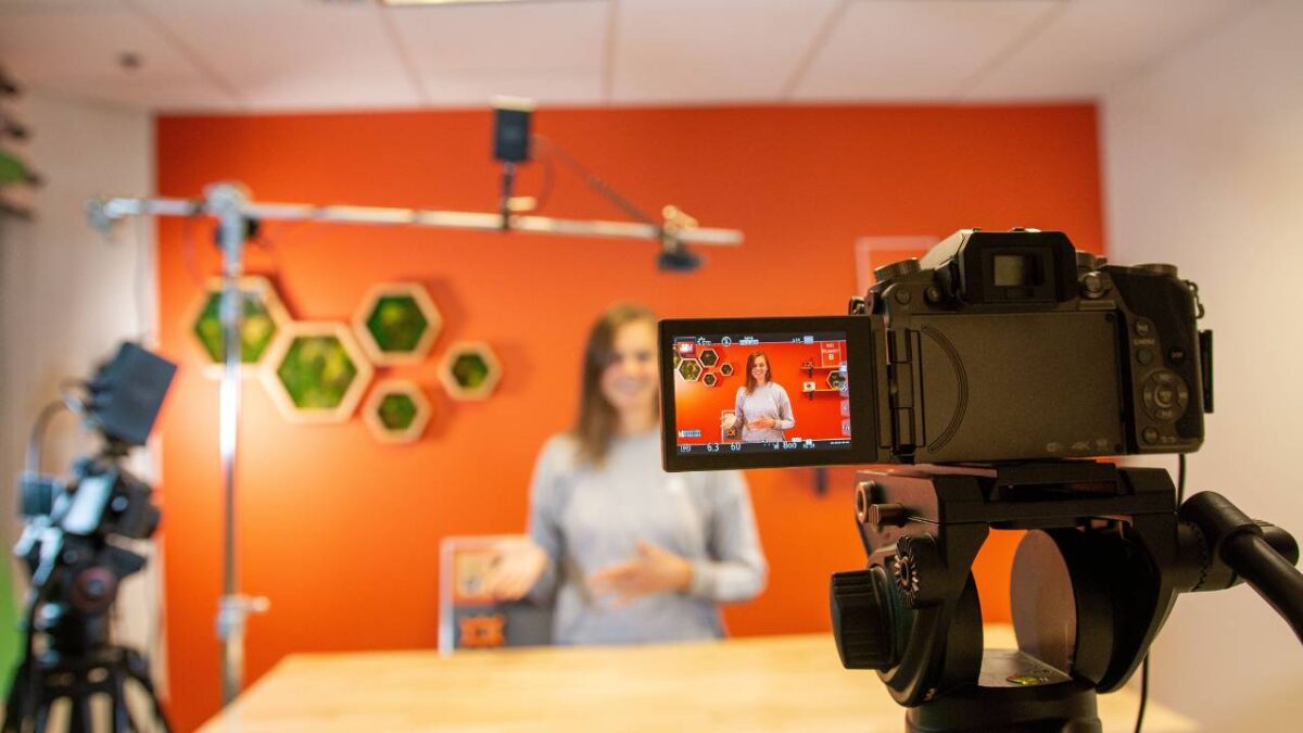 A woman being filmed with camera for an advertisement