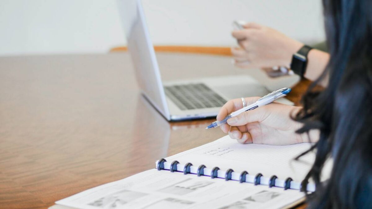 A woman taking important notes at a meeting