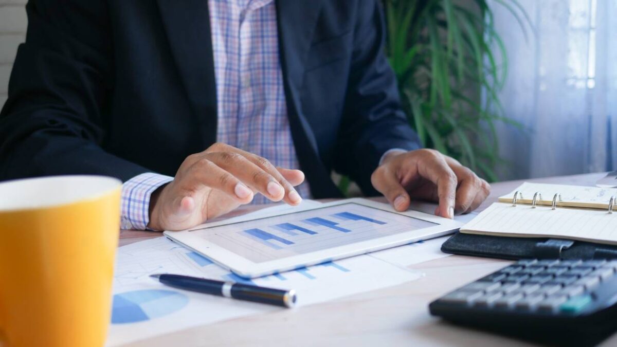 A financial advisor using a white tablet