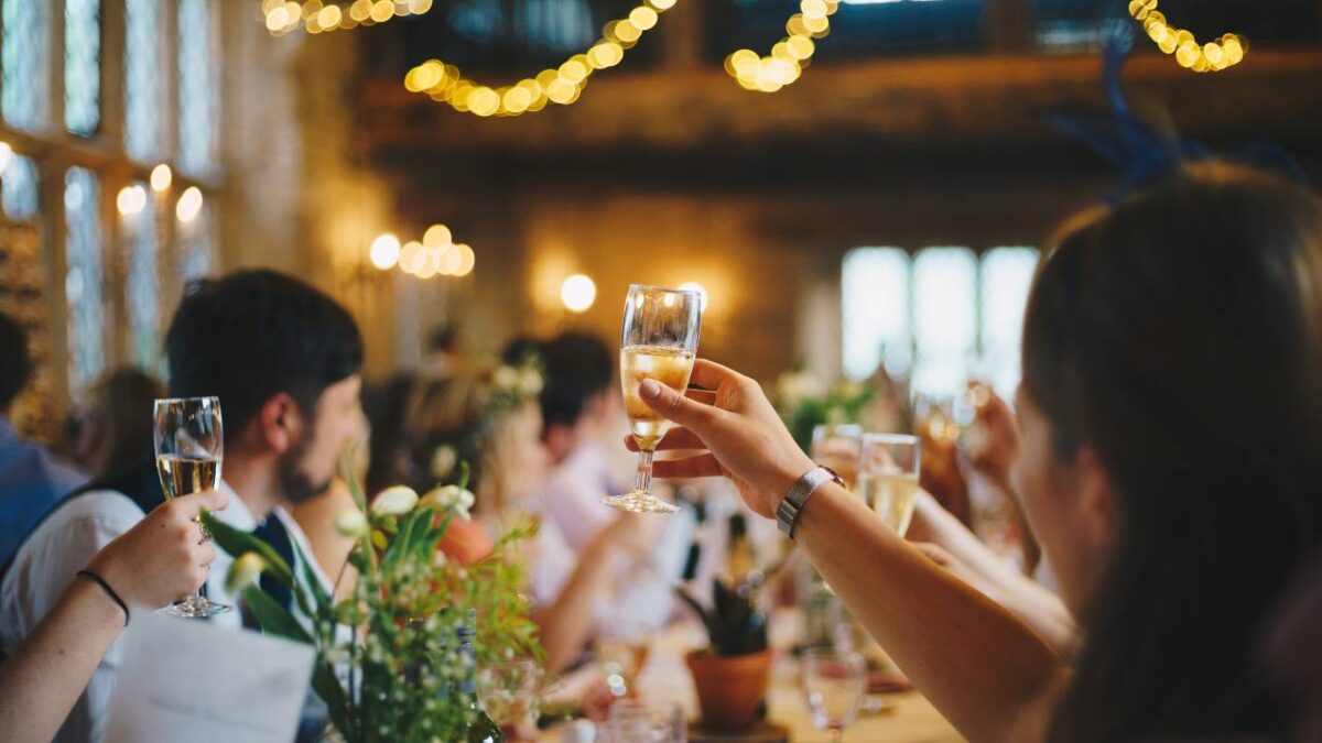 People holding glasses of wine at a business event