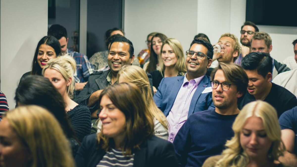 A group of people laughing together at a business conference