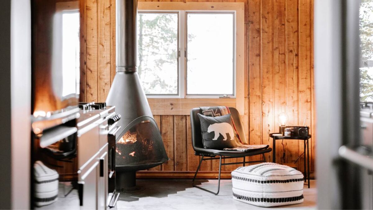 A comfy room with a stove and wooden walls