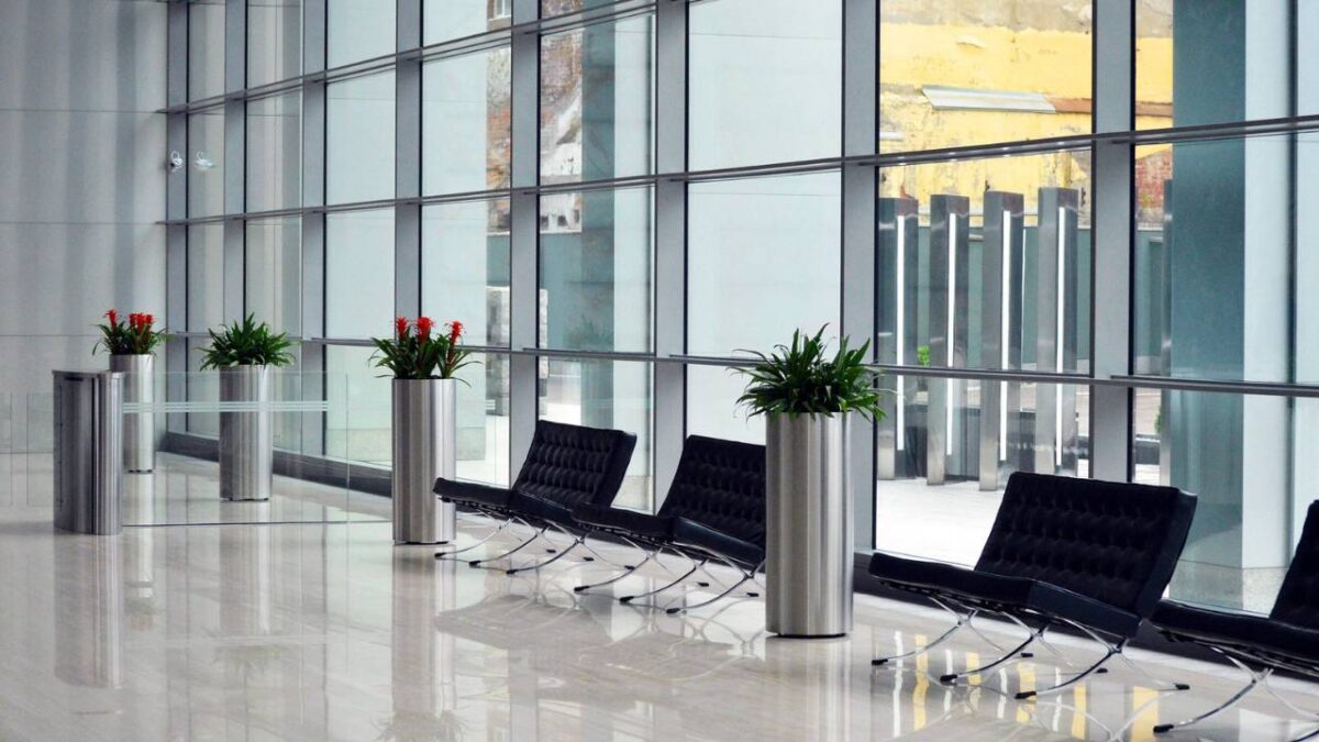 A spacious corporate lobby with chairs and plants