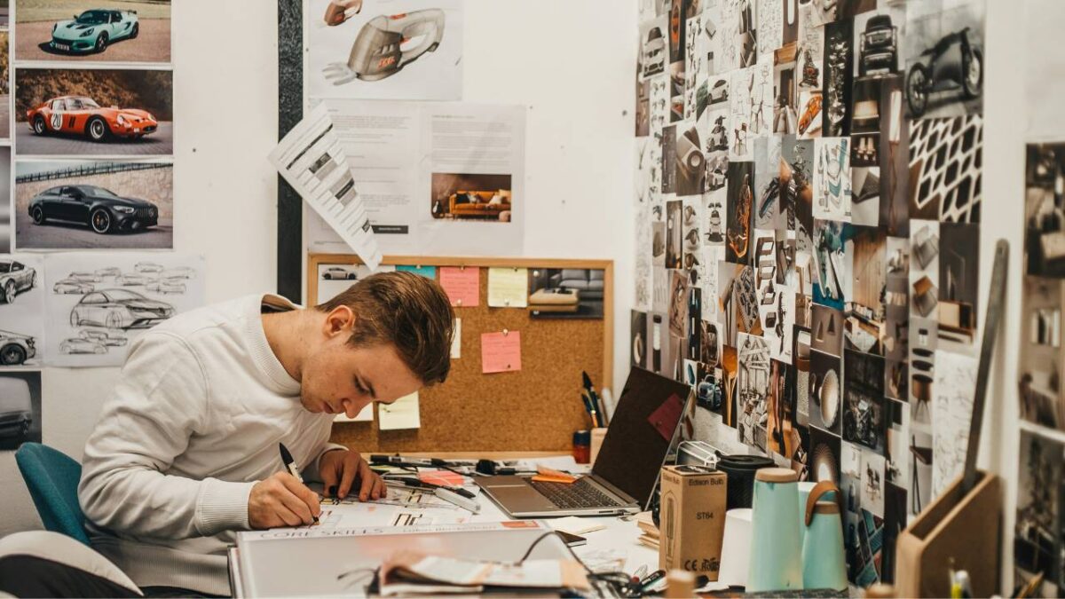 A young designer drawing in his workshop