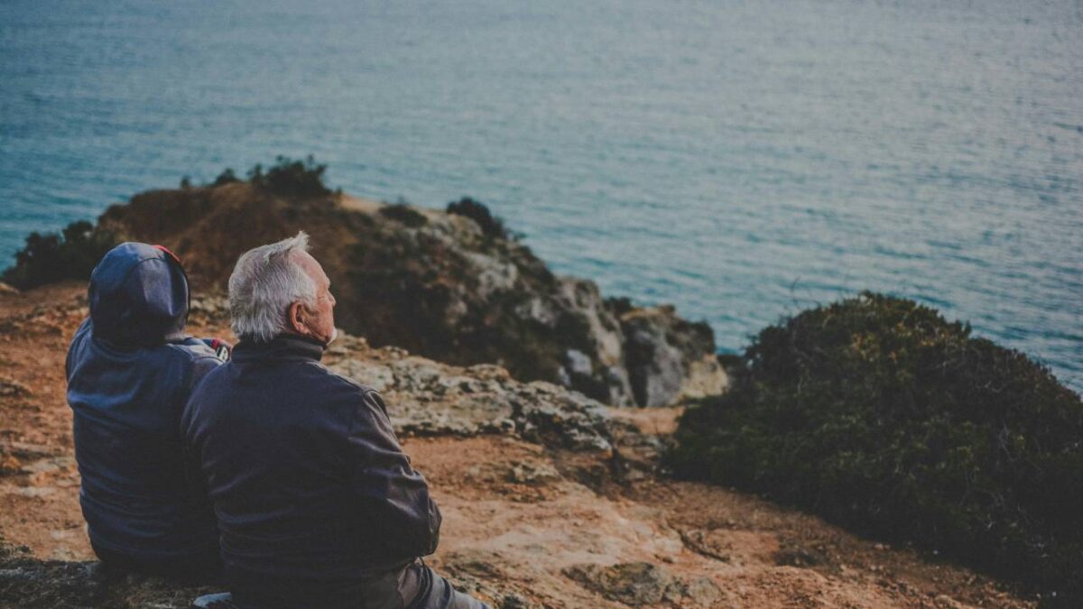 An elderly couple looking at the sea