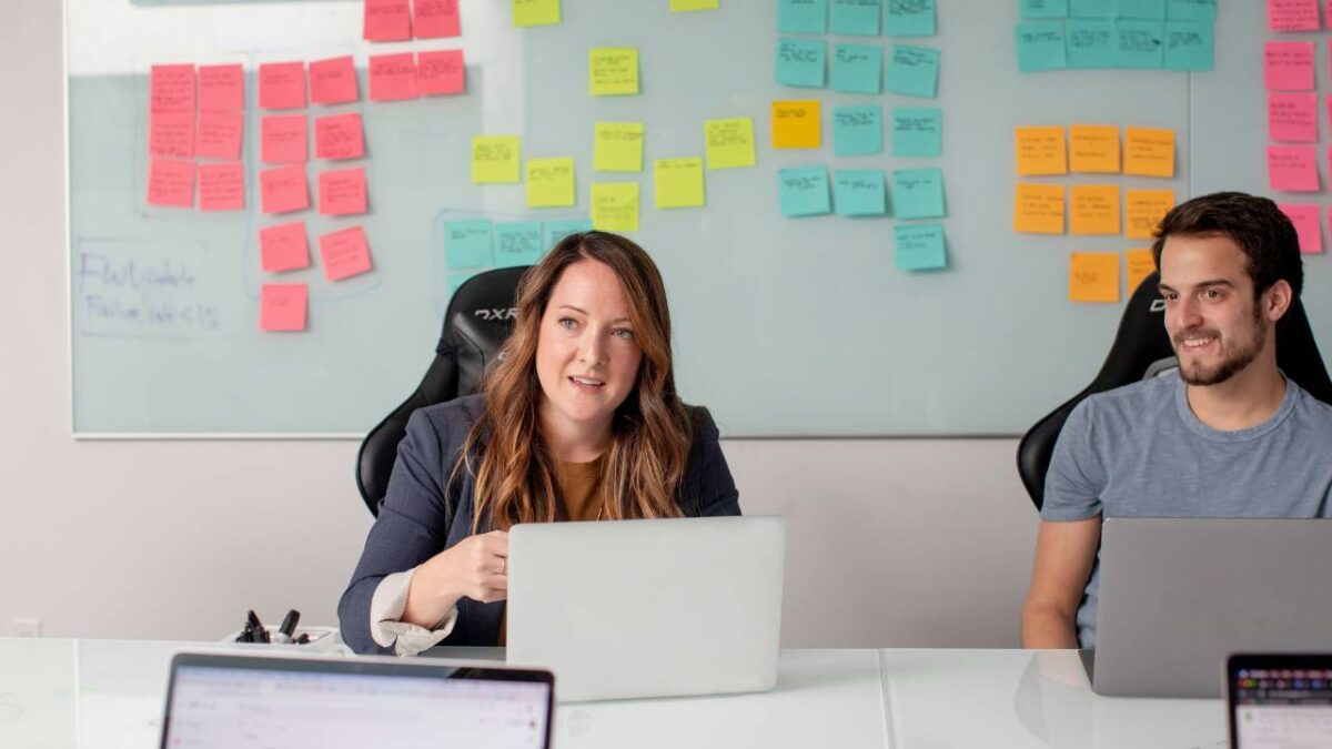 Female CEO talking to her employees in the meeting room 