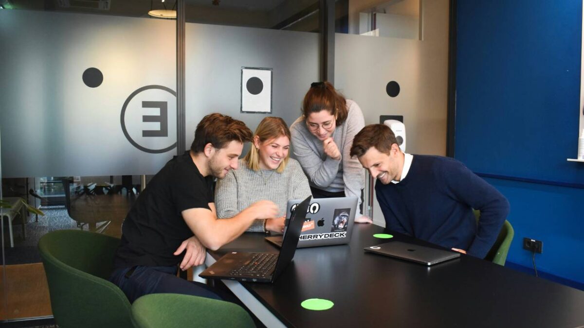 Four employees sharing a laugh in the conference room 