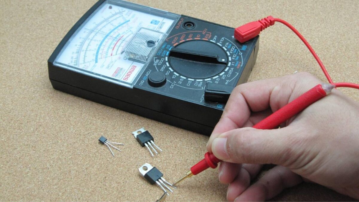A photo of a man testing electrical components with his PAT tester